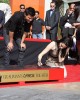 Kristen Stewart puts the date in the cement as Taylor Lautner watches at the TWILIGHT TRIO HANDPRINT AND FOOTPRINT CEREMONY | ©2011 Sue Schneider