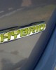 The logo of the 2012 KIA Optima Hybrid | ©2012 Midnight Productions Inc.