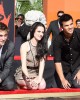Robert Pattinson, Kristen Stewart and Taylor Lautner sign at the TWILIGHT TRIO HANDPRINT AND FOOTPRINT CEREMONY | ©2011 Sue Schneider