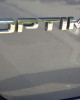 The logo of the 2012 KIA Optima Hybrid | ©2012 Midnight Productions Inc.