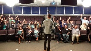 Jason Silva tests a groups hearing abilities on BRAIN GAMES | © 2014 National Geographic