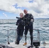 Ronda Rousey and Paul De Gelder pose before their dive beneath the waters off the Fiji coast in RHONDA ROUSEY UNCAGED | ©2018 Discovery Channel